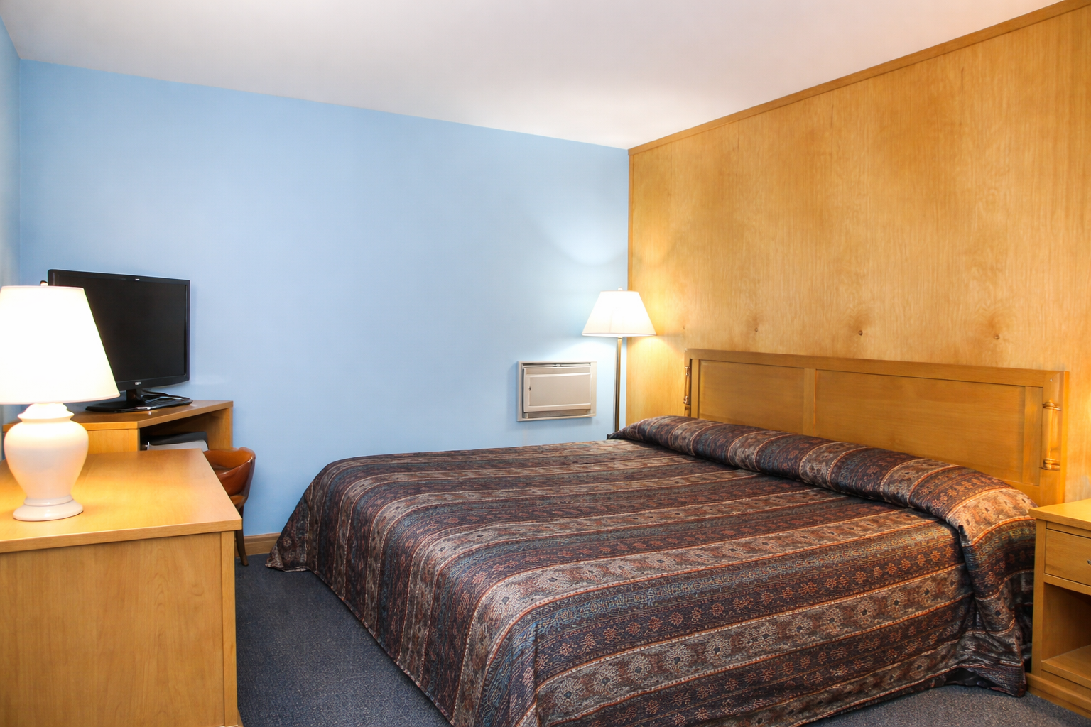 King room at Mohican Motel with desk and TV